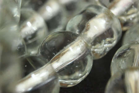 Macro photograph with selective focus of glass shiny prayer beads or rosary with copy space for text. Religion concept of ramadan or Eid for muslims.の写真素材