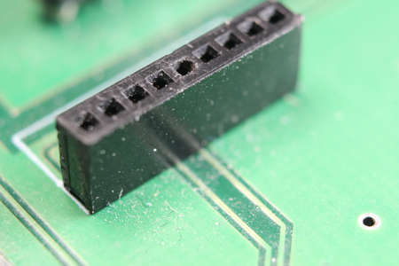 Electronic board with circuit lines and chip. Macro view of green boardの写真素材