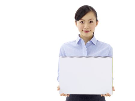 Young asian woman is holding empty text board over white backgroundの写真素材
