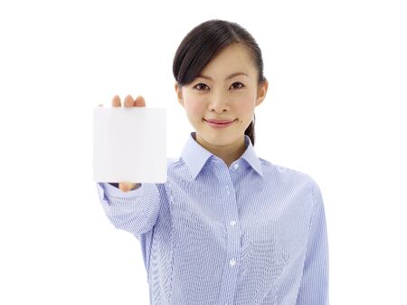Asian girl holding a white card. Isolated on white backgroundの写真素材