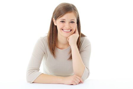Portrait of smiling woman resting her chin on handの写真素材