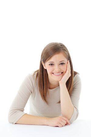 Portrait of smiling woman resting her chin on handの写真素材