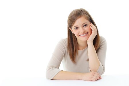 Portrait of smiling woman resting her chin on handの写真素材