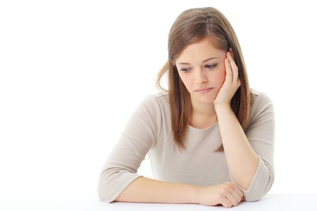 young blond woman thinking looking up isolated on whiteの写真素材