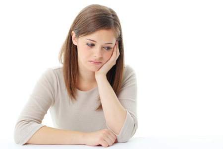young blond woman thinking looking up isolated on whiteの写真素材