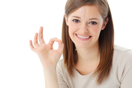Portrait of happy smiling businesswoman with okay gesture, isolated on white backgroundの写真素材