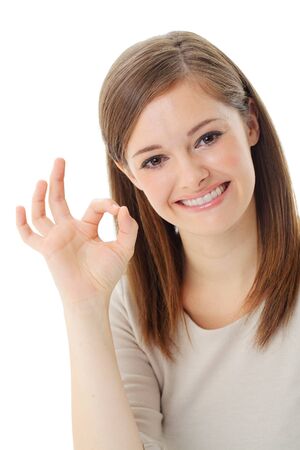 Portrait of happy smiling businesswoman with okay gesture, isolated on white backgroundの写真素材