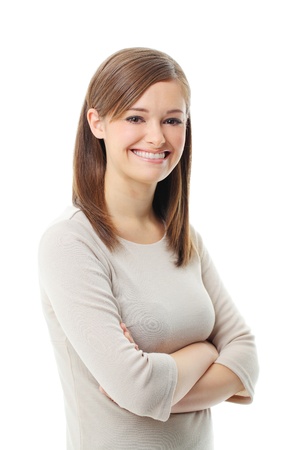 Young woman standing with folded hand against white background の写真素材