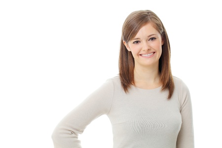 Young woman standing with folded hand against white background の写真素材