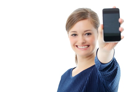 Young girl holding out mobile phoneの写真素材