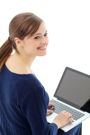 Top view of a lovely young lady using a laptop with a finger on her chin. の写真素材