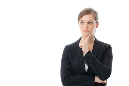 Thinking business woman smiling looking up at copy space. Beautiful young professional isolated on white background.の写真素材