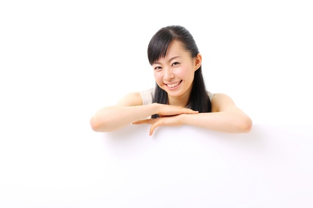 young business woman holding blank billboard, isolated on white backgroundの写真素材