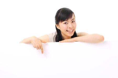 young business woman holding blank billboard, isolated on white backgroundの写真素材