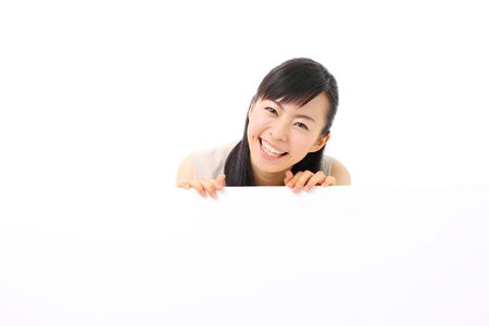 young business woman holding blank billboard, isolated on white backgroundの写真素材