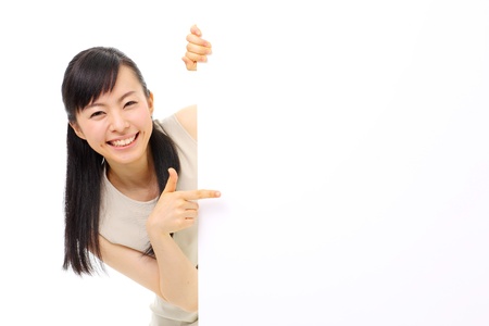young business woman holding blank billboard, isolated on white backgroundの写真素材