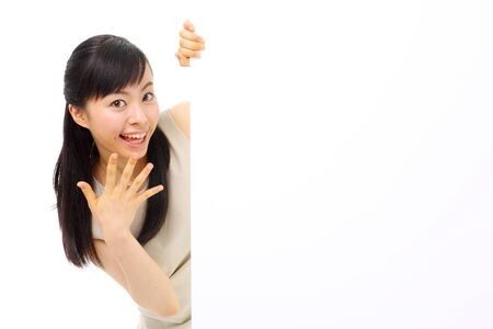 young business woman holding blank billboard, isolated on white backgroundの写真素材