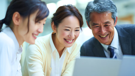 Business people working together on laptop computer at office desk. asianの素材