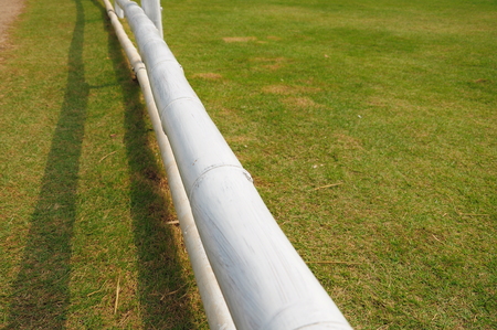 Short white bamboo fence in the gardenの写真素材
