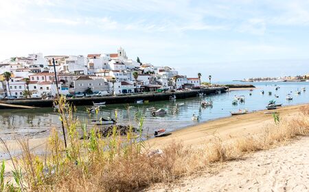 Ocean view, town at harbor and fishermen boatsの写真素材