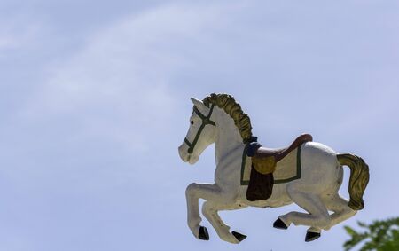 Flying horse from carousel - take a ride on a sunny dayの写真素材