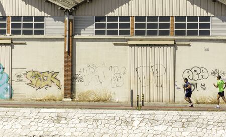 Riverside warehouse facing the waterfront -  well kept with graffiti and plenty of water and sun