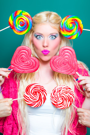 Blonde beauty with Lollipops in Handの写真素材