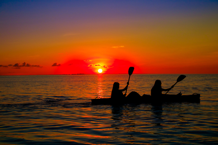 Woman silhouette on waterの写真素材