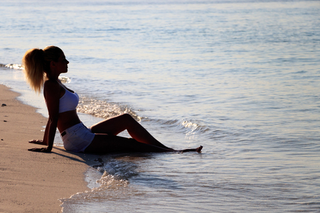Woman silhouette on waterの写真素材