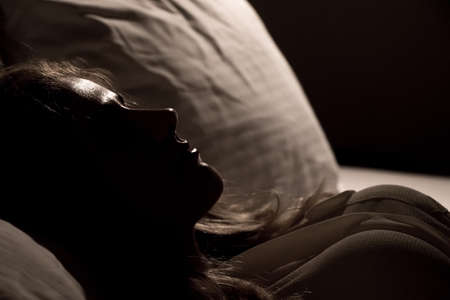 Girl sleeping in bedの写真素材