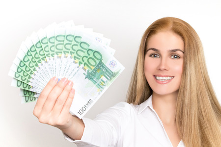 Gorgeous blonde woman holds 100 euro banknotes fanned in her handsの写真素材