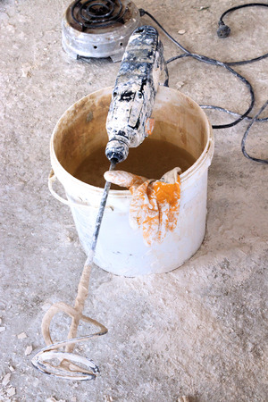 Plaster mixer bucket and gloveの写真素材