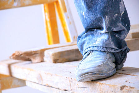 Construction worker with jeans and street shoesの写真素材