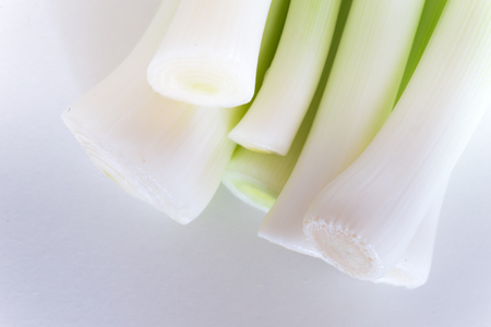 Leeks stack on cutting Boardの写真素材