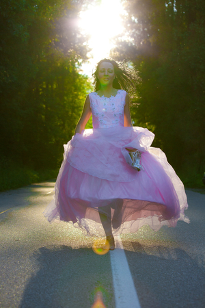 Woman with pink dress on the streetの写真素材