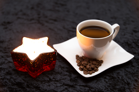 Hot coffee with christmas candleの写真素材