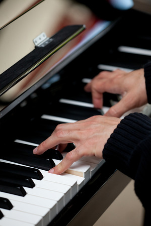 Piano keys with human handの写真素材