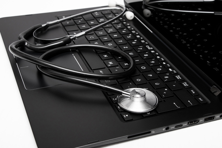 Stethoscope placed on keyboardの写真素材