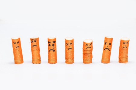 Facial expressions with cigarette buttsの写真素材