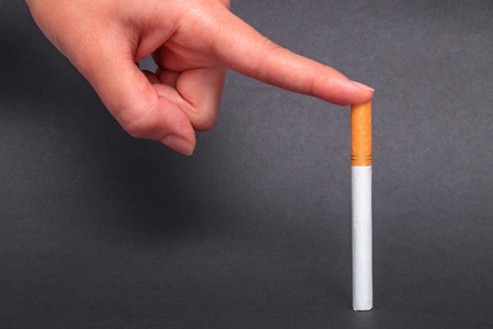 Finger punctures a cigaretteの写真素材