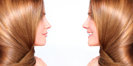 Profiles of two beautiful women with long blond hairの写真素材