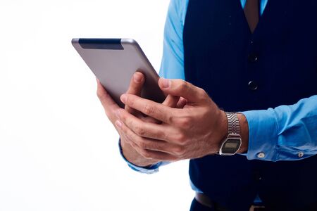 tablet in the hands of a man wearing a blue shirtのeditorial素材