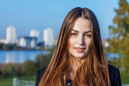 beautiful young girl on the background of nature at sunsetの写真素材