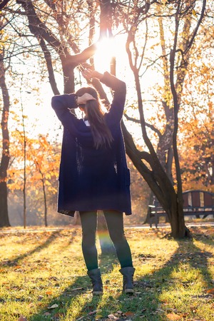 beautiful girl at sunset in autumn forestの写真素材
