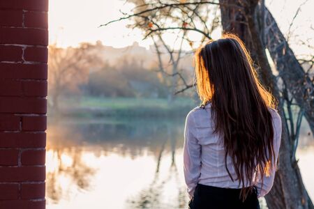 beautiful girl at sunset in autumn forestの写真素材