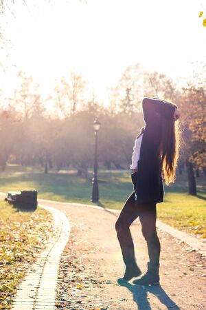 beautiful girl at sunset in autumn forestの写真素材