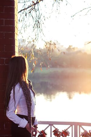 beautiful girl at sunset in autumn forestの写真素材