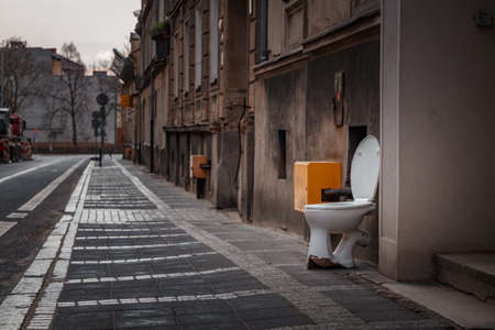 toilet standing in the middle of an old European streetの写真素材