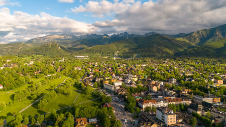 aerial view of the city of Zakopane and the city around in the evening in Poland at sunsetの写真素材