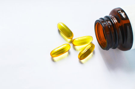 Fish oil capsules on white background and texture., Fish oil capsules and container., selective...